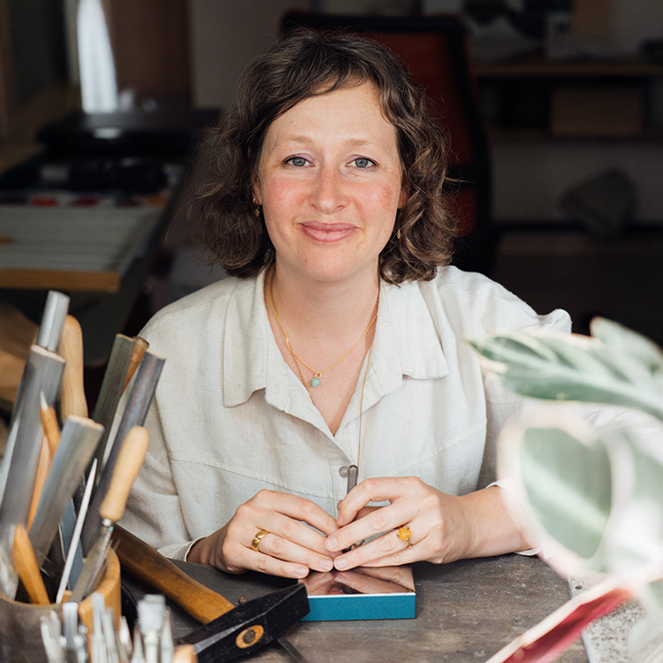 Portrait der Goldschmiedemeisterin Maike Thomas in ihrer Werkstatt am Werktisch